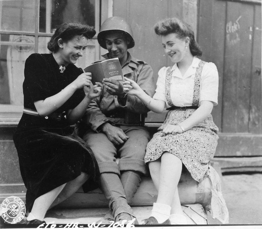 World War II Solider Reading with Two Women